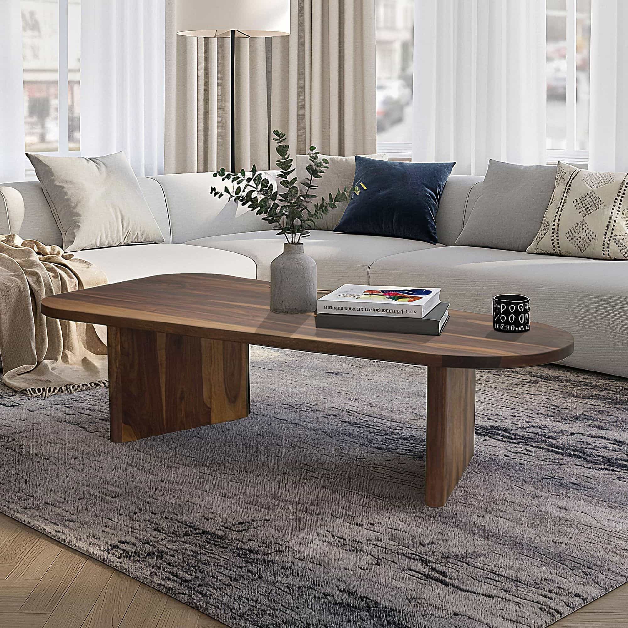 Couchtisch Sheesham Massivholz oval 120cm · Handgefertigter Wohnzimmertisch im modernen Design mit abgerundeter Form · Flacher Sofatisch aus Echtholz Couchtisch Sheesham Massivholz oval 120cm · Handgefertigter Wohnzimmertisch im modernen Design mit abgerundeter Form · Flacher Sofatisch aus Echtholz